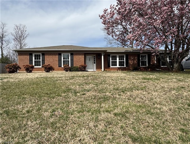 single story home with a front lawn and brick siding