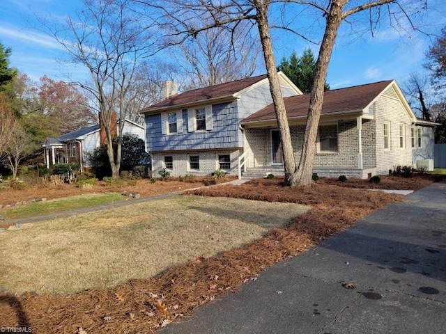 tri-level home with a front yard