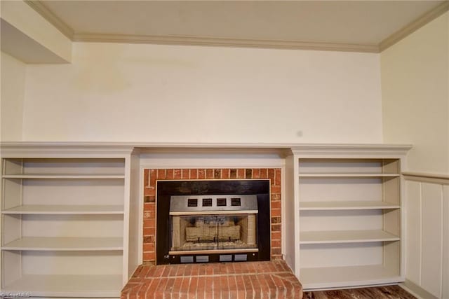 interior details with built in features, wood-type flooring, a brick fireplace, and crown molding