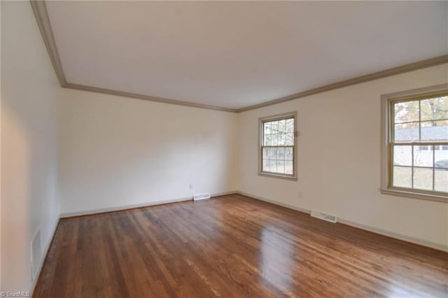 unfurnished room with dark hardwood / wood-style flooring and ornamental molding