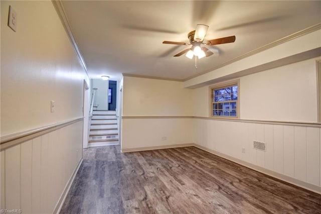 basement with hardwood / wood-style flooring, ceiling fan, and ornamental molding