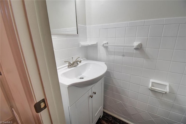 bathroom with vanity and tile walls