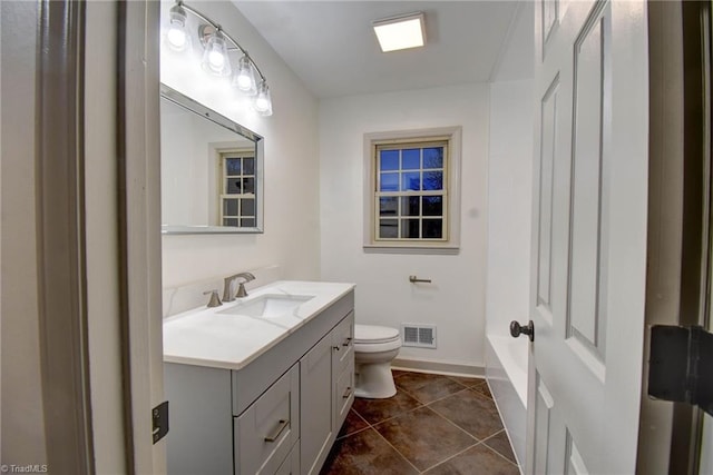 bathroom featuring tile patterned floors, vanity, and toilet