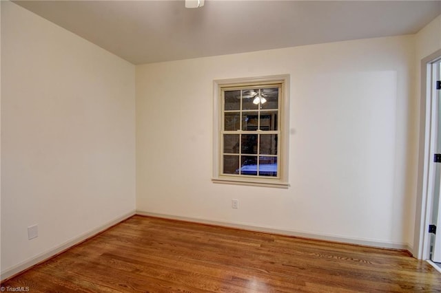 spare room featuring wood-type flooring