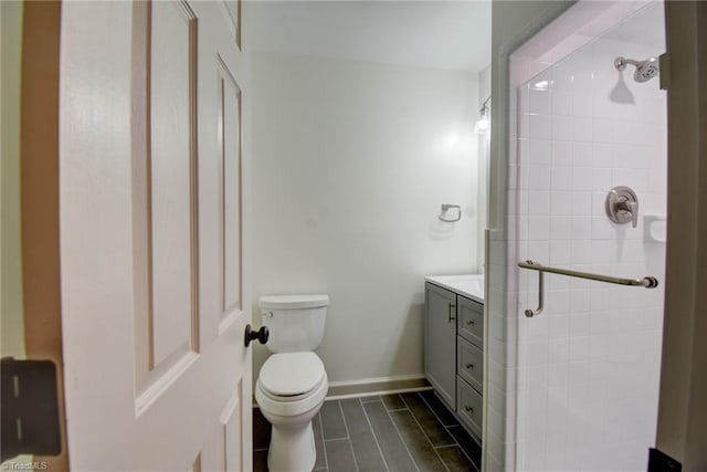 bathroom with toilet, vanity, and walk in shower