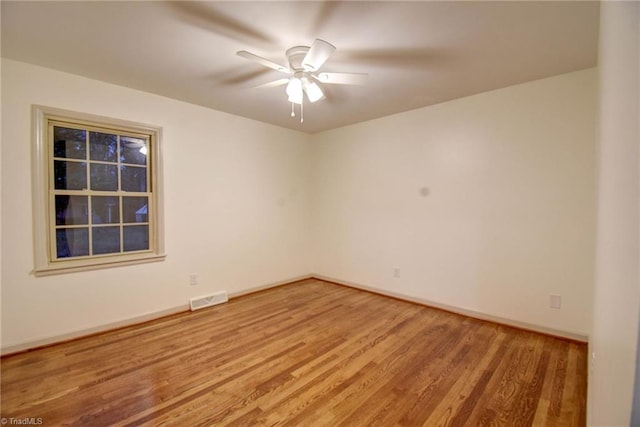 empty room featuring ceiling fan and hardwood / wood-style flooring