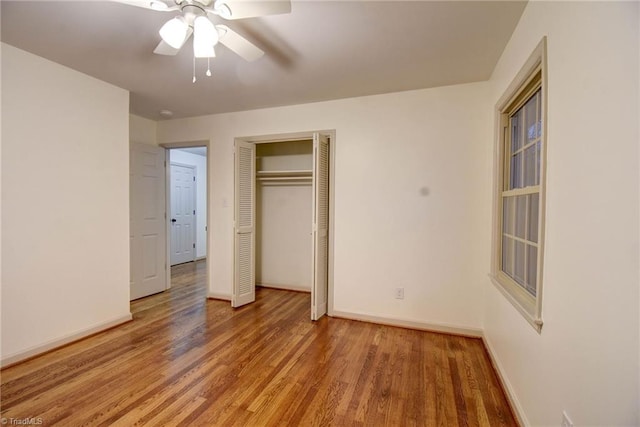 unfurnished bedroom featuring wood-type flooring, a closet, and ceiling fan