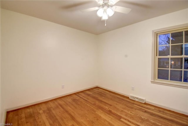 spare room with hardwood / wood-style floors and ceiling fan