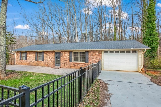 ranch-style home with a garage, a shingled roof, concrete driveway, fence, and brick siding