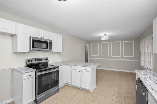 kitchen with light stone counters, a peninsula, white cabinetry, appliances with stainless steel finishes, and tasteful backsplash