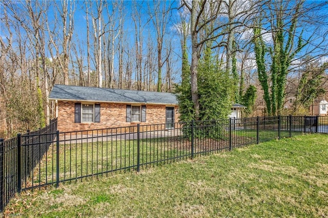 exterior space featuring brick siding, a lawn, and a fenced backyard