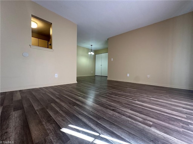 unfurnished living room featuring dark wood-type flooring