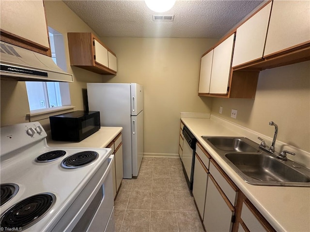 kitchen featuring a textured ceiling, white cabinets, sink, and white appliances