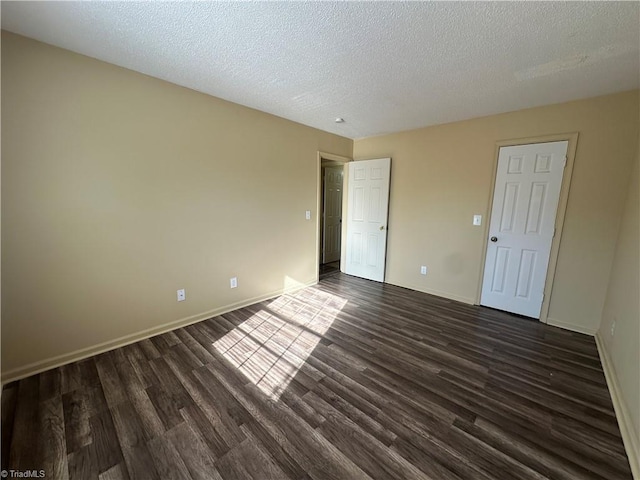 unfurnished bedroom featuring a textured ceiling and dark wood-type flooring