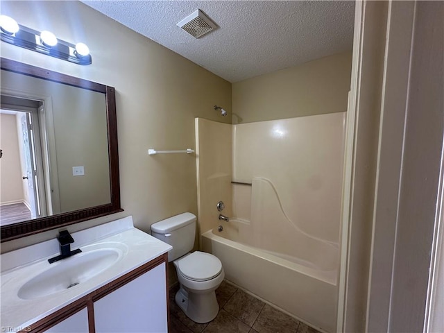 full bathroom featuring a textured ceiling, toilet, shower / bath combination, tile patterned floors, and vanity