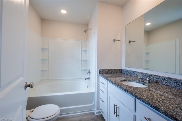 full bathroom with toilet, wood finished floors,  shower combination, vanity, and recessed lighting