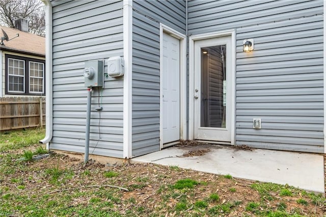 entrance to property with a patio and fence