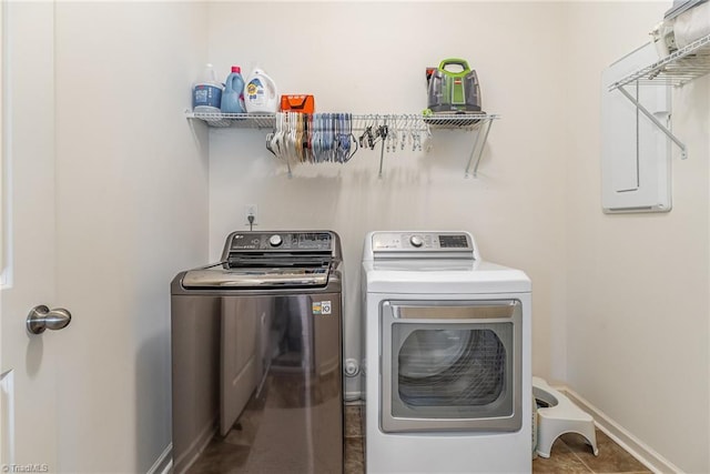 5838 Springer Dr, Greensboro, NC 27405 - laundry area with independent washer and dryer, baseboards, and tile patterned floors