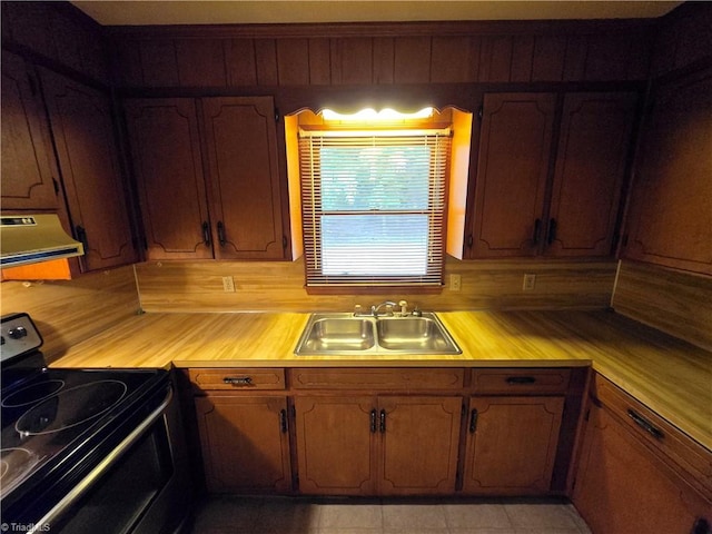 kitchen featuring light tile patterned floors, sink, wooden counters, black electric range, and exhaust hood