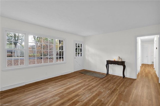 spare room with hardwood / wood-style floors and a wealth of natural light