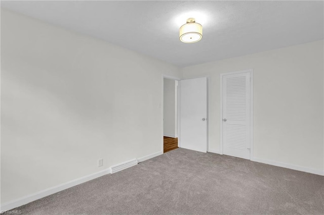 unfurnished bedroom with carpet flooring and a closet