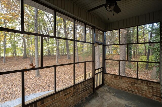 unfurnished sunroom with ceiling fan