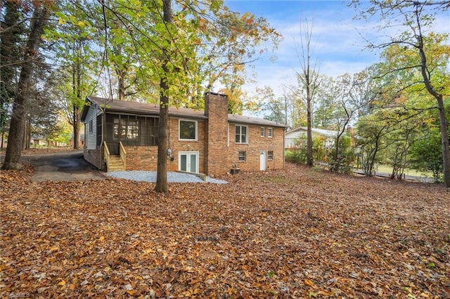 rear view of house with a sunroom