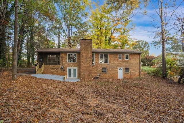 back of house featuring a sunroom and french doors