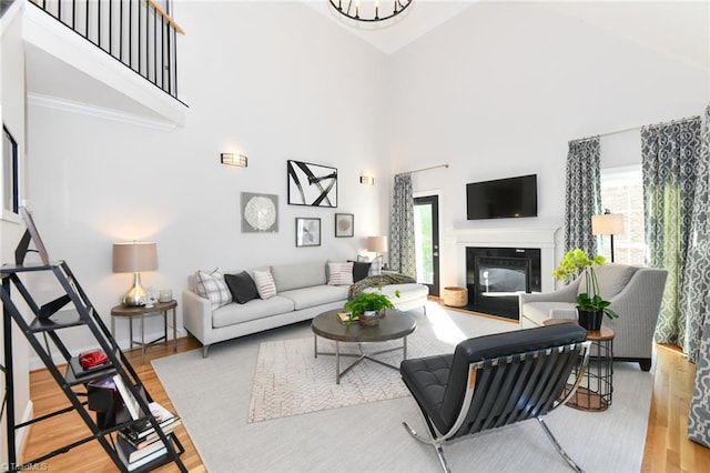 living room featuring wood-type flooring and a towering ceiling