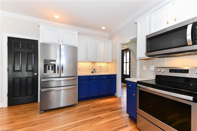 kitchen featuring blue cabinetry, white cabinetry, tasteful backsplash, light hardwood / wood-style floors, and appliances with stainless steel finishes