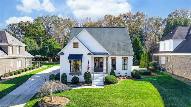 view of front of house featuring a front lawn and central AC unit