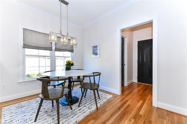 dining room featuring hardwood / wood-style flooring and crown molding