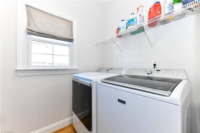 laundry area featuring light hardwood / wood-style flooring and washer and dryer