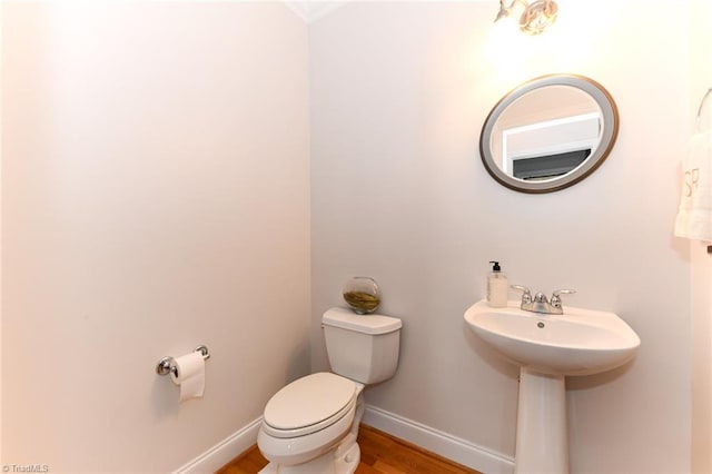 bathroom featuring hardwood / wood-style floors and toilet