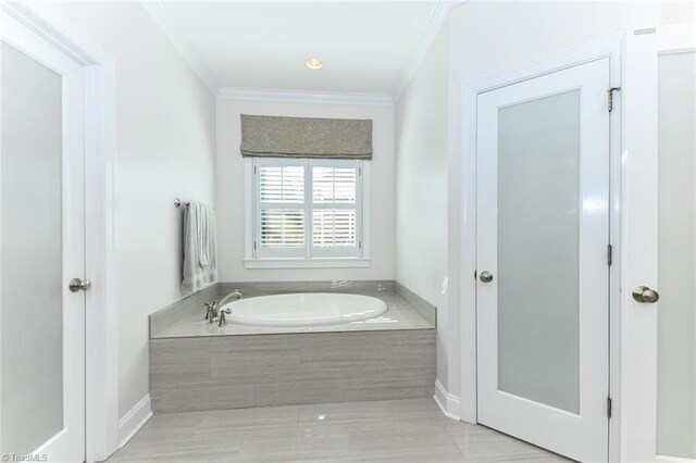 bathroom featuring tiled tub and crown molding