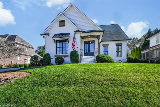 view of front of home featuring french doors and a front lawn