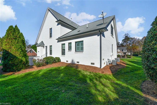 back of house featuring a lawn and central air condition unit