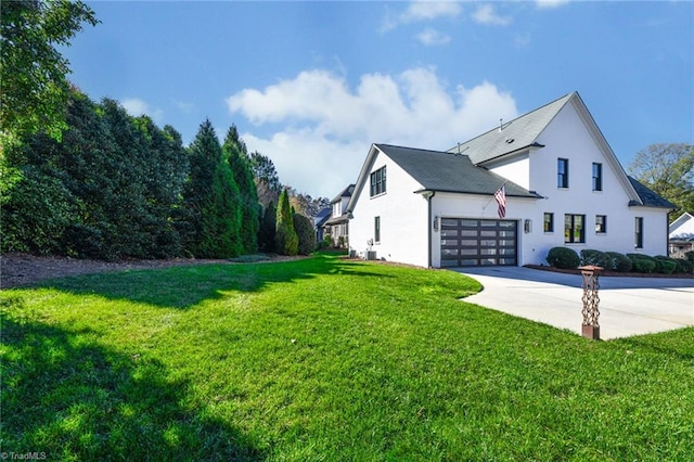 view of home's exterior featuring a lawn and a garage