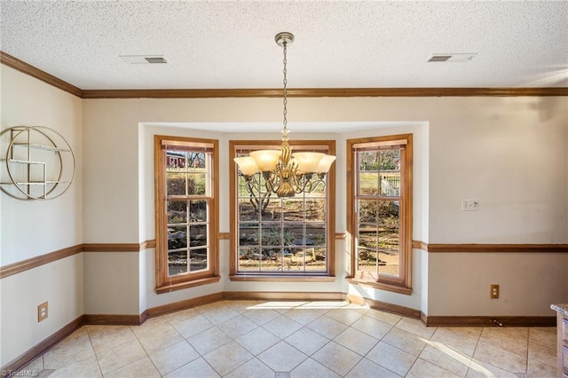 unfurnished dining area featuring an inviting chandelier, light tile patterned floors, ornamental molding, and a textured ceiling