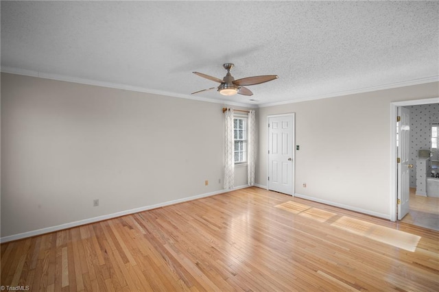 spare room with crown molding, ceiling fan, a textured ceiling, and light hardwood / wood-style floors