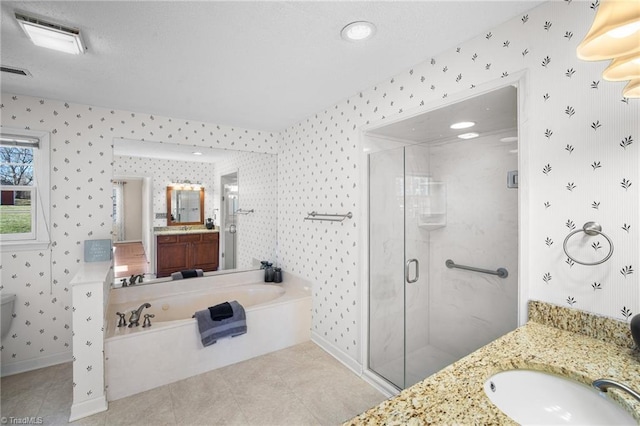 bathroom with vanity, shower with separate bathtub, and tile patterned flooring