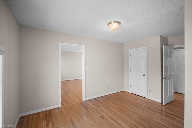 interior space featuring light hardwood / wood-style flooring and a textured ceiling