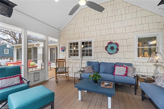 sunroom with a ceiling fan and vaulted ceiling