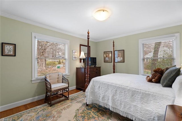 bedroom featuring crown molding, wood finished floors, and baseboards