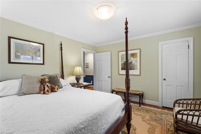 bedroom featuring baseboards, light wood-style floors, and crown molding