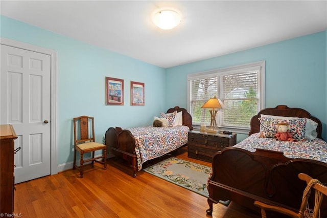 bedroom featuring wood finished floors and baseboards