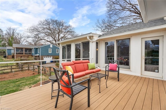 deck featuring outdoor lounge area, fence, and a sunroom