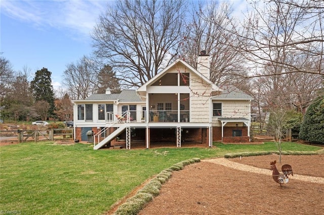 back of house with fence, stairway, a lawn, a chimney, and a sunroom