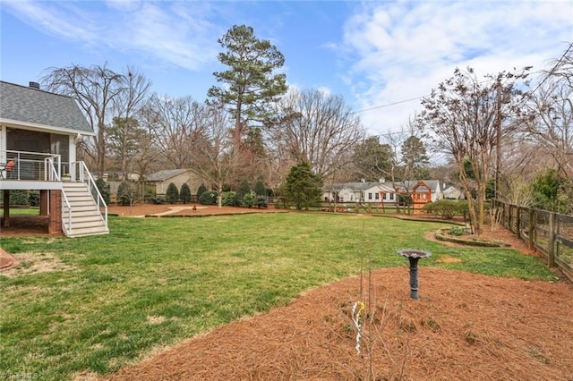 view of yard featuring stairway and fence