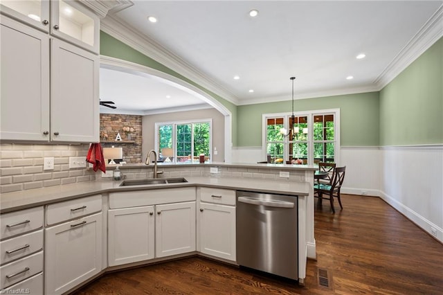 kitchen with stainless steel dishwasher, white cabinetry, a sink, and a peninsula